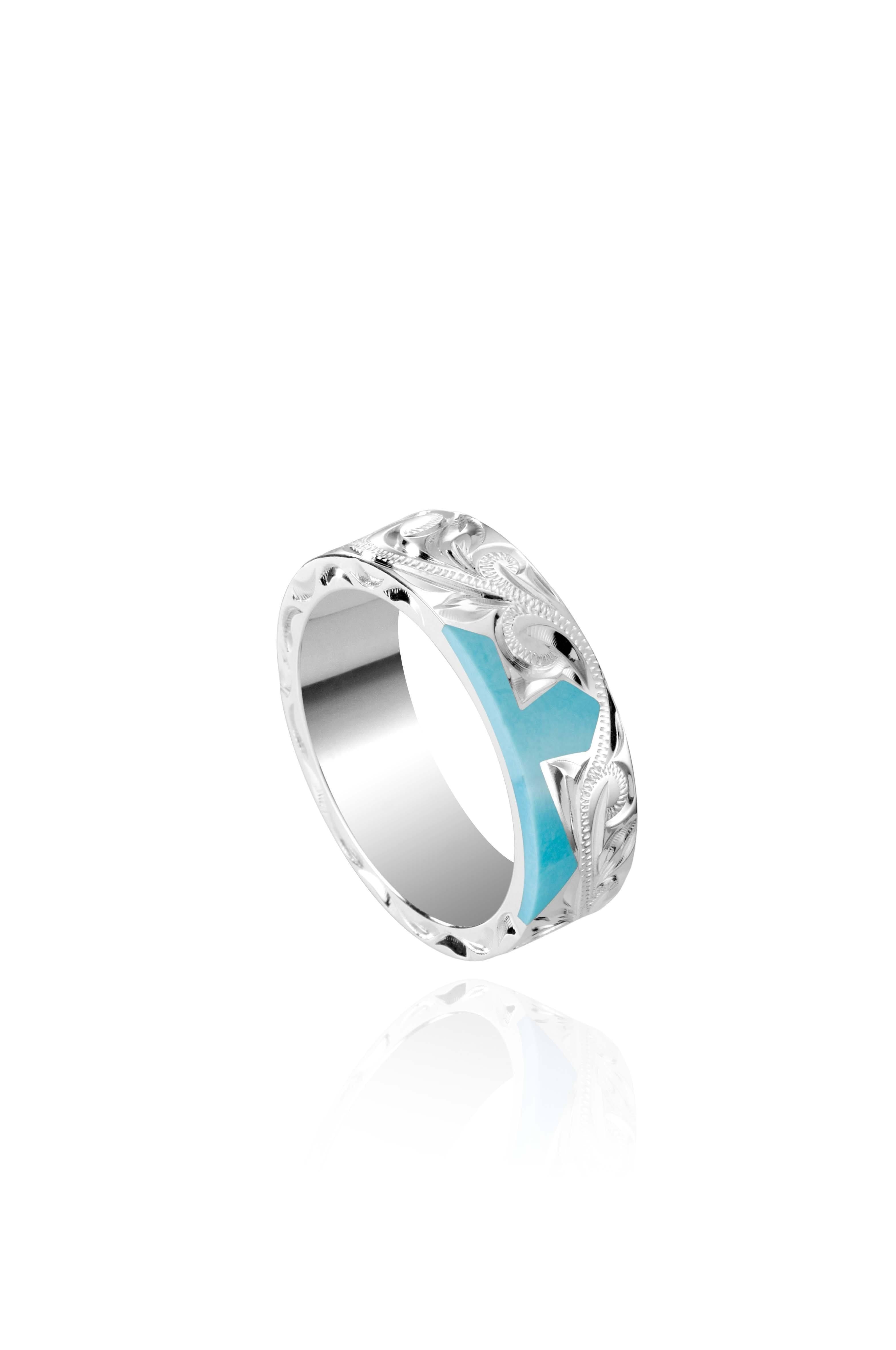 The picture shows a part of a set 925 sterling silver right half cross ring with hand-engravings and a turquoise gemstone.