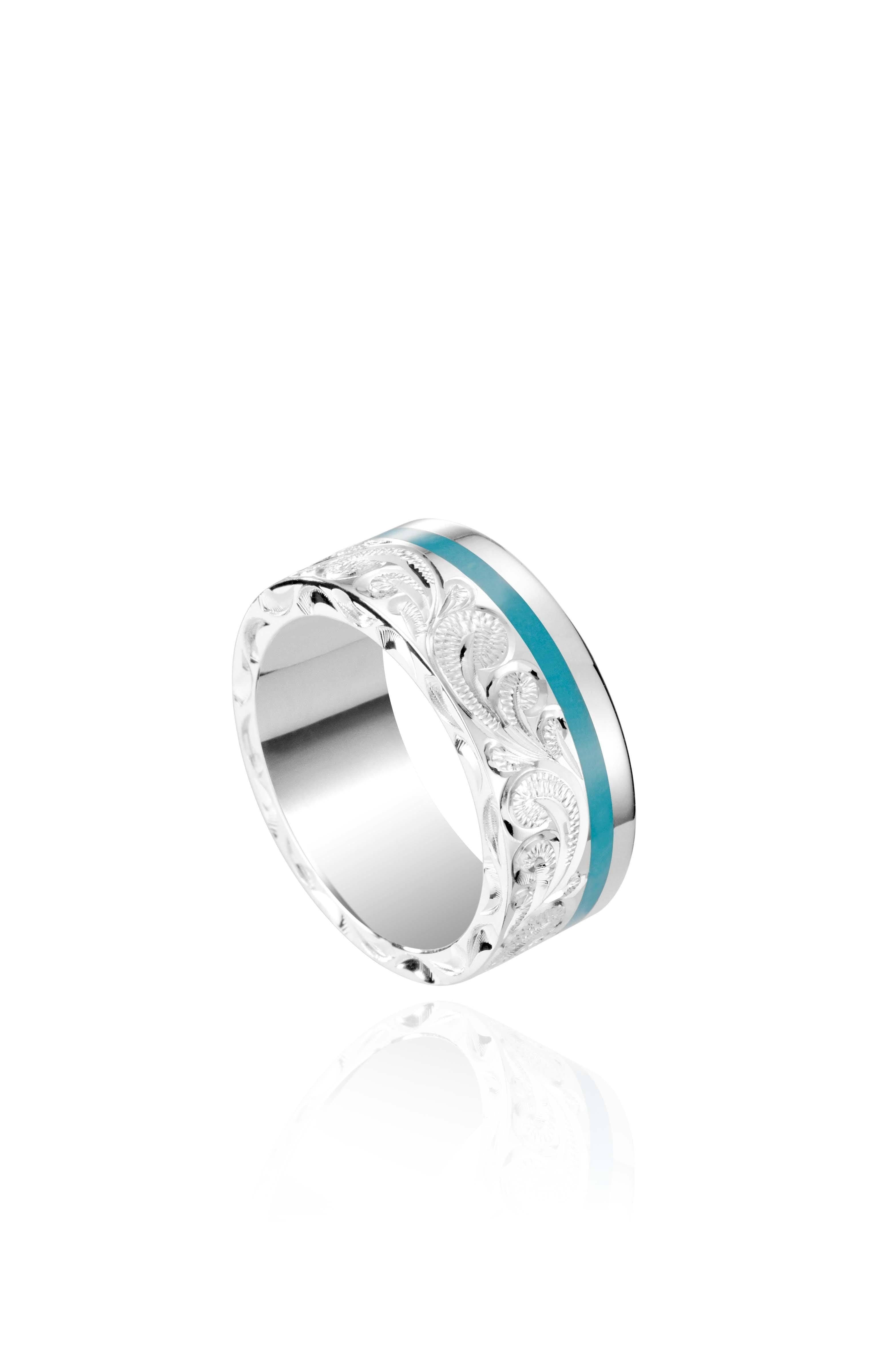 The picture shows a 925 sterling silver and turquoise wave channel ring with hand engravings.