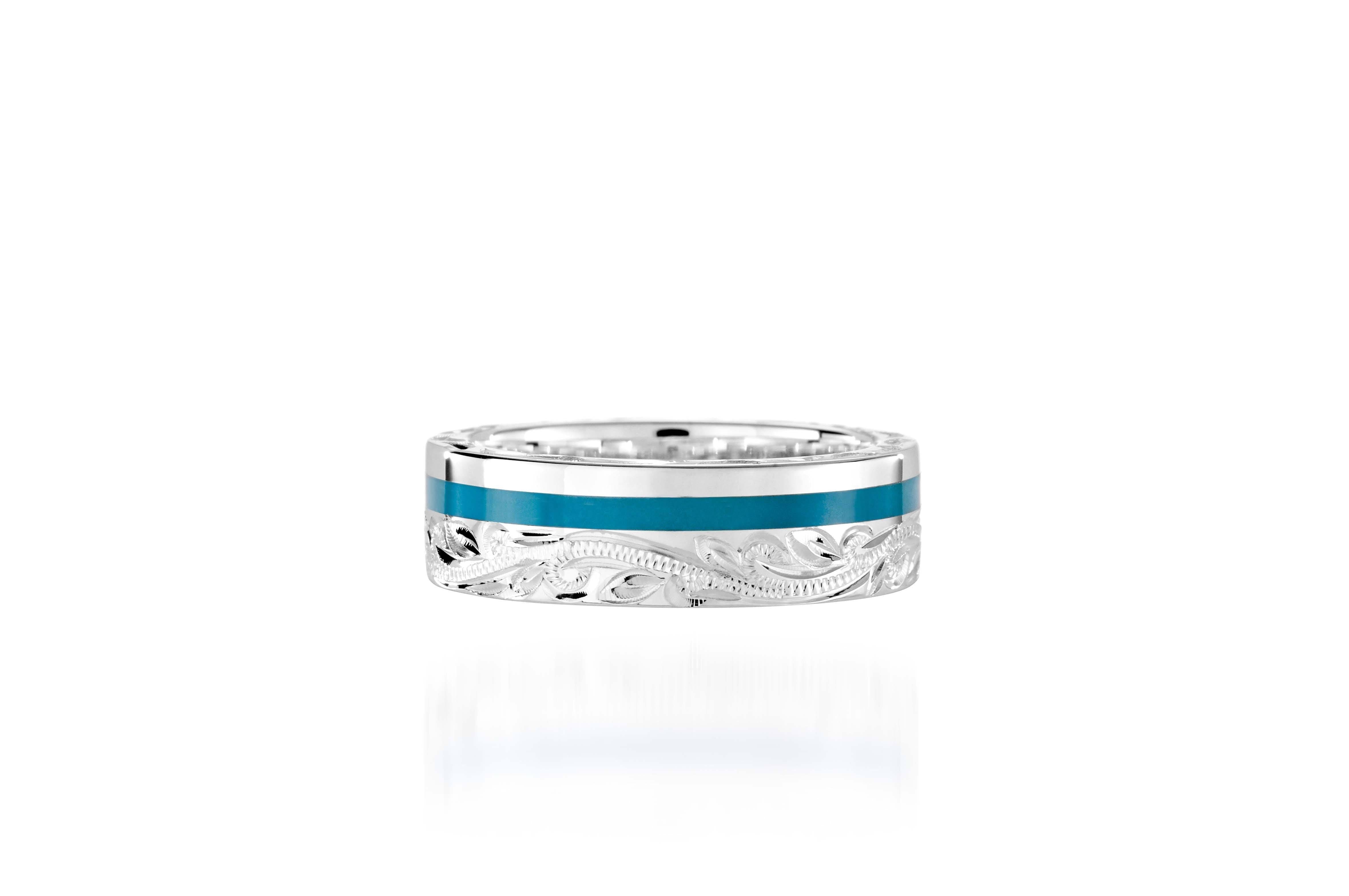 The picture shows a 925 sterling silver and turquoise wave channel ring with hand engravings.