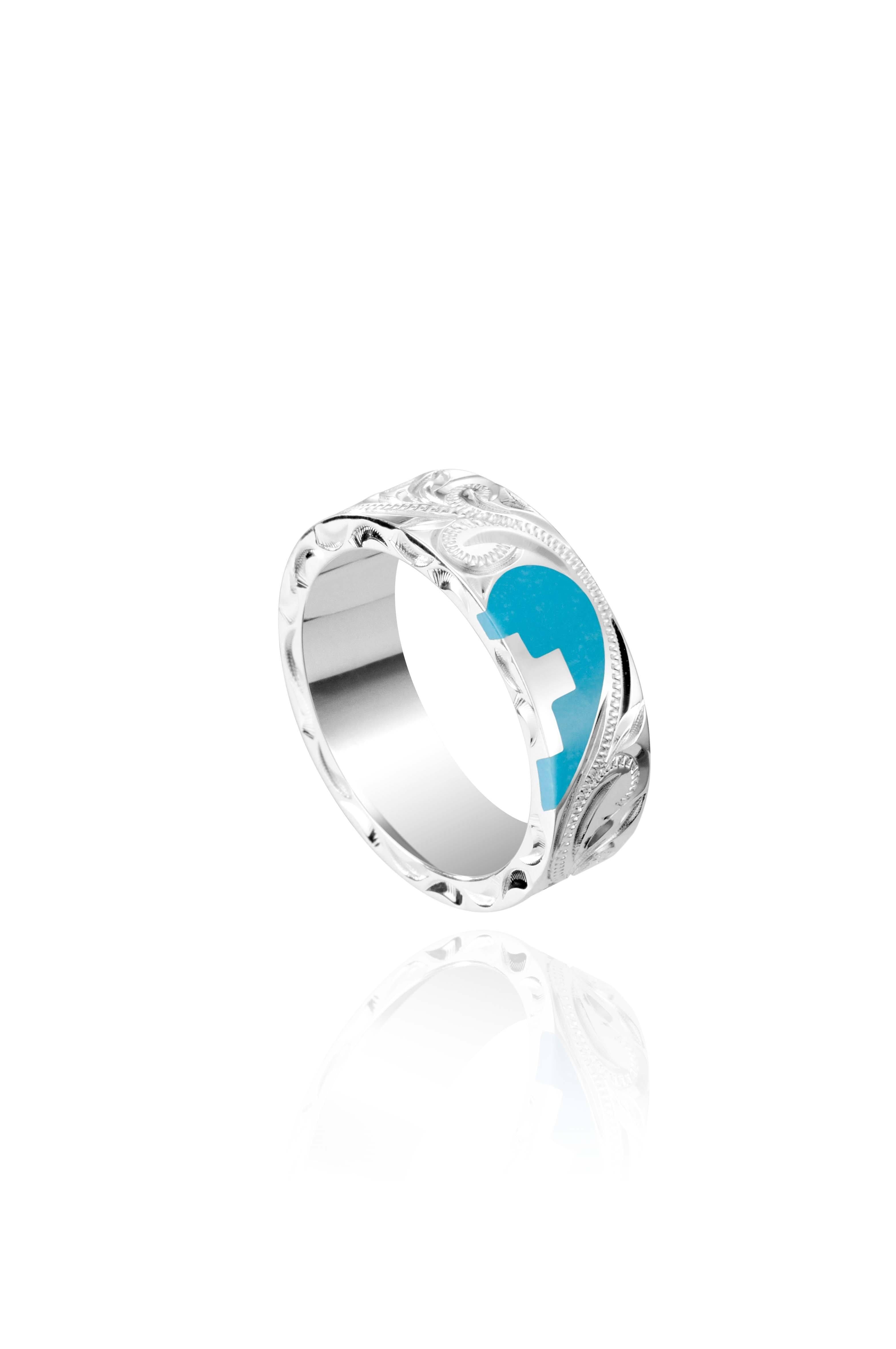 The picture shows a 925 sterling silver and turquoise heart with a cross matching ring with hand engravings.
