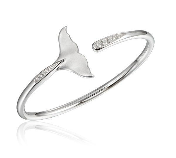 The picture shows a 925 sterling silver whale tail bangle with topaz.